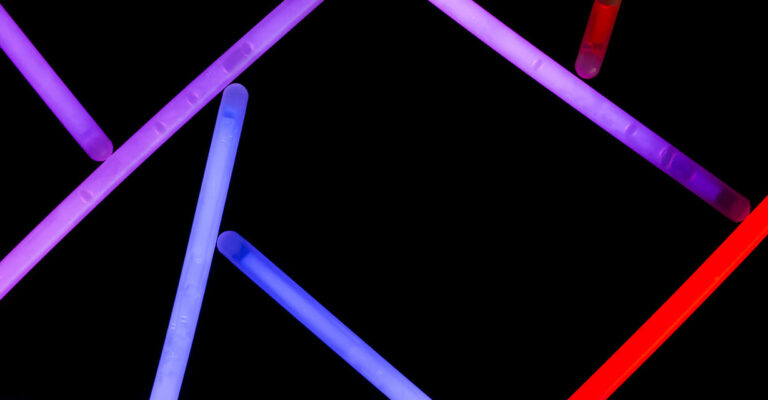 Purple blue and red neon straws on dark background